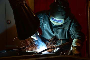 Industrial steel welder in factory welder, craftsman