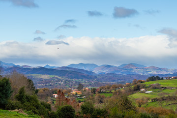 Mountain range in clear weather in contrasting rain clouds before the rain