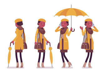 Stylish young black woman with umbrella, wearing autumn clothes