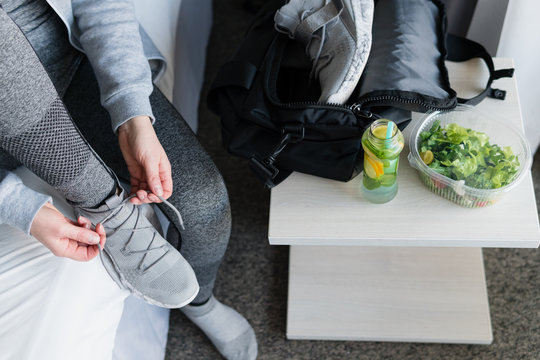 Female athlete getting ready for athletic and fitness training. Drinks, diet, detox and people concept healthy eating.