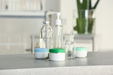 Jars with cream and glassware on table in laboratory