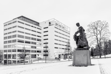 High key, winter, black and white photography of a building and statue at the back of it in the city Zlin, Czech Republic, Europe.