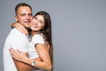 Portrait lovely sensual couple hugging, sexy girl looking at camera isolated on grey background