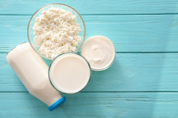 Different milk products on color wooden table