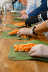 cook cuts red fish fillet