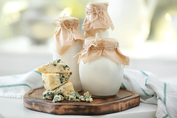 Different milk products on wooden board