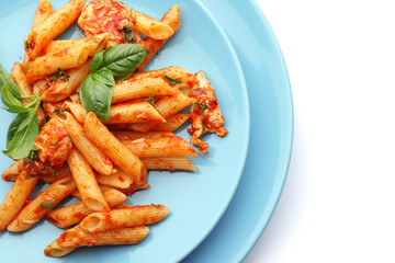 Plates with tasty penne pasta on white background