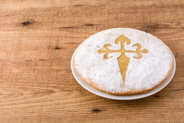 Tarta de Santiago. Traditional almond cake from Santiago in Spain on wooden table. Copyspace