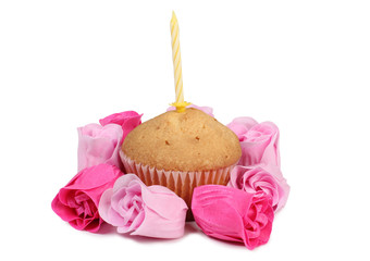 Fresh sweet cupcake with a candle on a white background