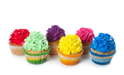 Delicious colorful cupcakes on white background