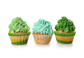 Delicious colorful cupcakes on white background