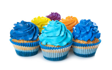 Delicious colorful cupcakes on white background