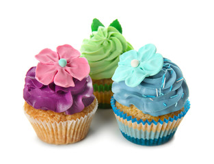 Delicious colorful cupcakes on white background