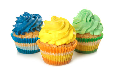 Delicious colorful cupcakes on white background
