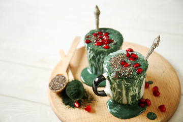 Cups of spirulina smoothie on table