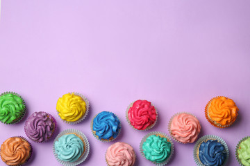 Different cupcakes on color background