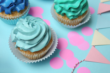 Different cupcakes on color background