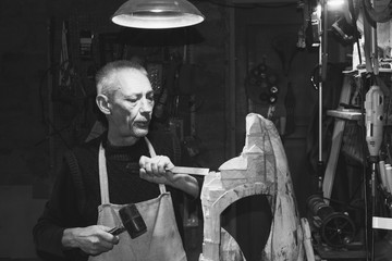 master carpenter working in his woodwork workshop, black and white photography