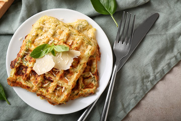 Plate with tasty squash waffles on table