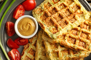 Tasty squash waffles with sauce on metal tray, closeup