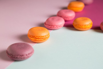 Multi-colored macaroons on a colored background