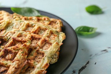Plate with tasty squash waffles on light table, closeup