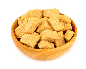 Brown Unrefined Single Evaporated Demerara Cane Sugar Cube Chunk Pieces in Wooden Bowl, Isolated on White Background.