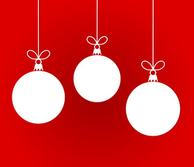 White Christmas hanging baubles on red background.
