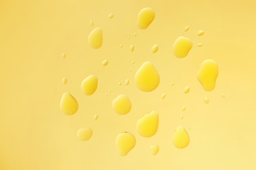 Drops of oil on color background