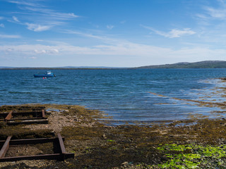 Fototapeta na wymiar pier on the irish sea with fishing boat