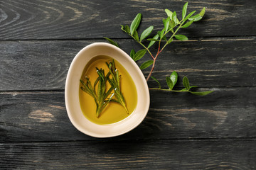 Plate of fresh olive oil on dark wooden table