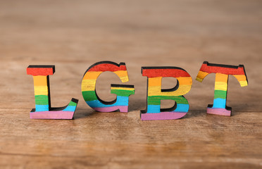 Rainbow letters LGBT on wooden table