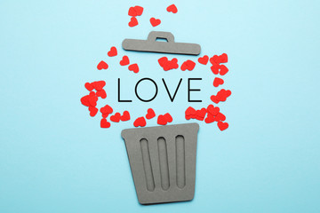 Divorce of couple,  red hearts in trash can. Love and hatred, separation.