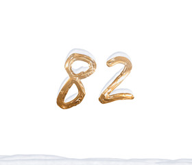 Gold Number 82 with Snow on white background