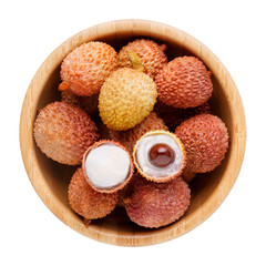 Fresh lychee in wooden bowl isolated on white background. Top view.