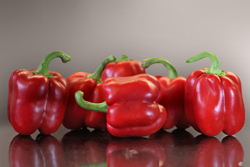 Pods of red sweet pepper lying on the table