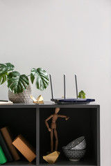 Modern wi-fi router on dark shelf - obrazy, fototapety, plakaty