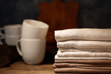 Stack of clean kitchen towels on wooden table