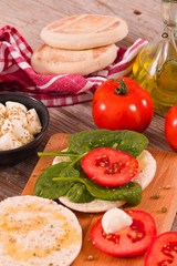 Tigella bread with spinach and tomatoes.