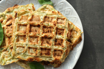 Plate with tasty squash waffles on grey table, closeup