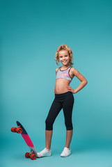 Smiling little sports girl playing with a skateboard © Drobot Dean