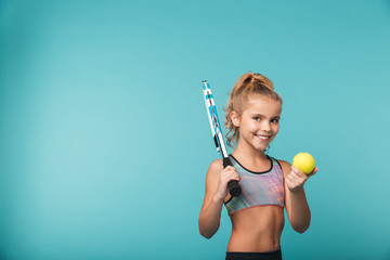 Cheerful young sports girl playing tennis