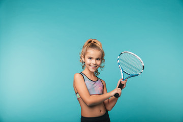 Cheerful young sports girl playing tennis
