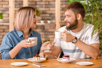 Loving young couple during romantic date in cafe