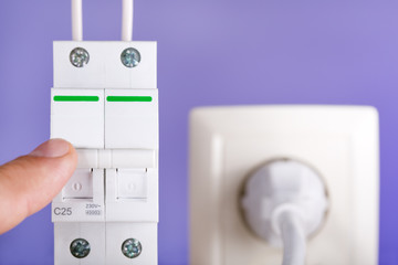 Electrician turns of the switch. Power outage. Energy saving concept. no payment for energy.