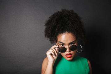 Beautiful african woman wearing sunglasses posing