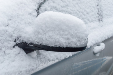 Snow on car wing mirror.