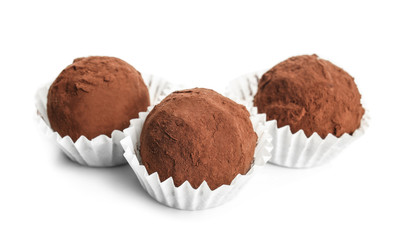 Tasty chocolate truffles on white background