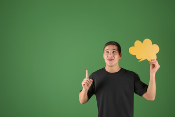 Thoughtful young man with speech bubble on color background