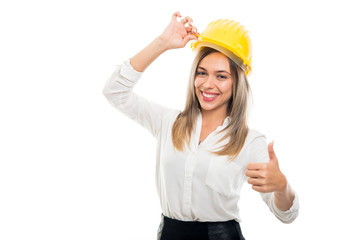 Beautiful business woman wearing yellow hardhat showing like
